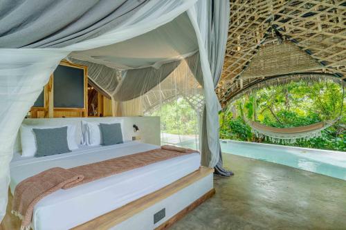 a bedroom with a bed in a tent at Bamboo Zanzibar in Jambiani