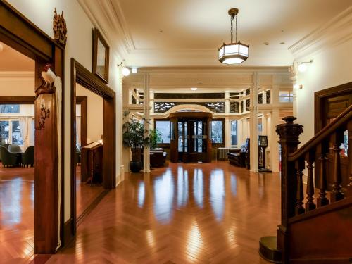 an empty lobby with a hard wood floor and a staircase at The Fujiya Hotel in Hakone