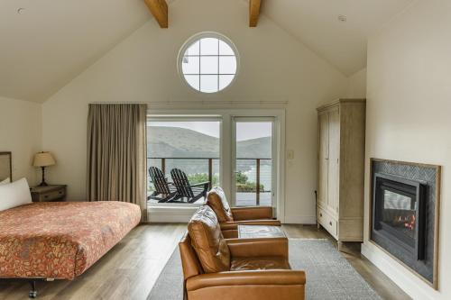 a bedroom with a bed and a fireplace at SCP Mendocino Coast Lodge in Albion