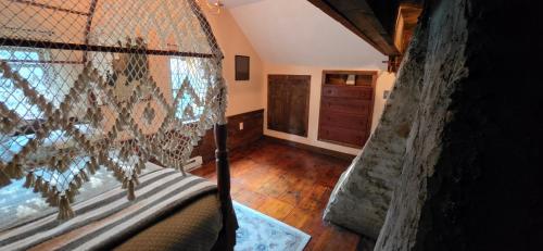 a bedroom with a canopy bed and a dresser at JOSIAH KEITH HOUSE museum & inn in Five Corners