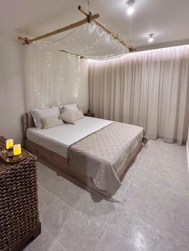 a bedroom with a large bed with lights on it at Sigma Exotic Palio Beach Apartment in Paleo Tsifliki
