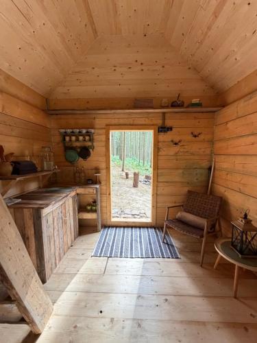 an inside view of a log cabin with a window at Glamping Olivia v lese in Radíč