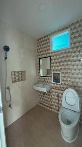 a bathroom with a toilet and a sink at Aysaii Home02 in Panwa Beach
