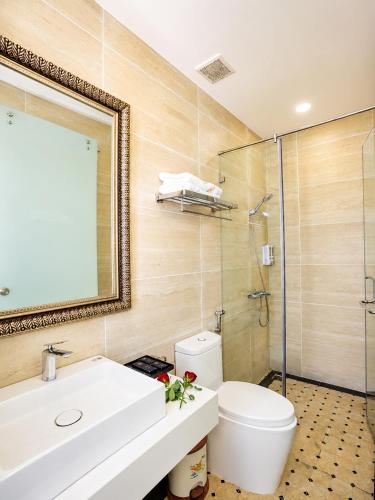 a bathroom with a sink and a toilet and a shower at Laimeront Hotel Dalat Vietnam in Da Lat