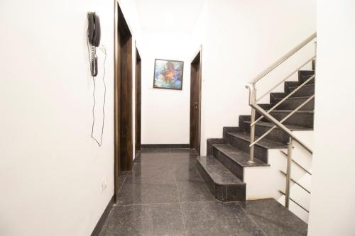 a hallway with stairs and a phone on the wall at Hotel O Sai Plaza in Aurangabad