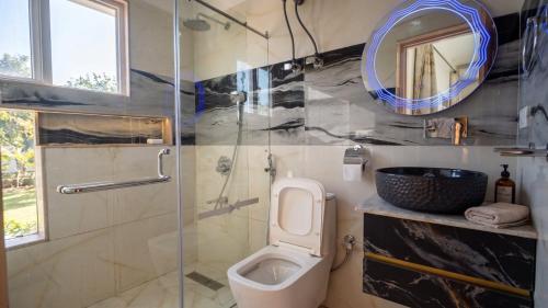 a bathroom with a toilet and a glass shower at Hariparbatview in Srinagar