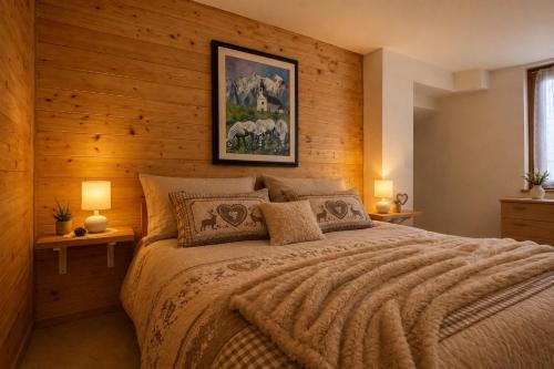 a bedroom with a large bed with wooden walls at Maso Patrizia - Rifugio caldo tra le vette in Pieve Tesino