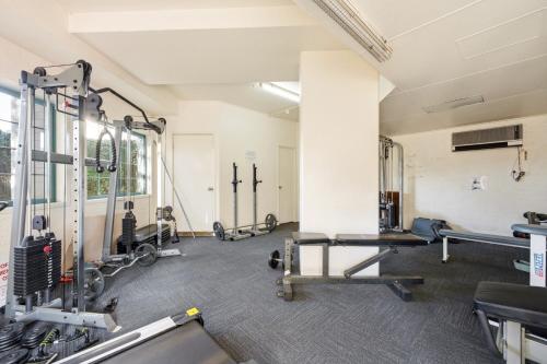 a gym with several treadmills and machines at Stylish 2-Bed Apartment in Kingston in Kingston 