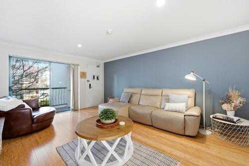 a living room with a couch and a table at Stylish 2-Bed Apartment in Kingston in Kingston 