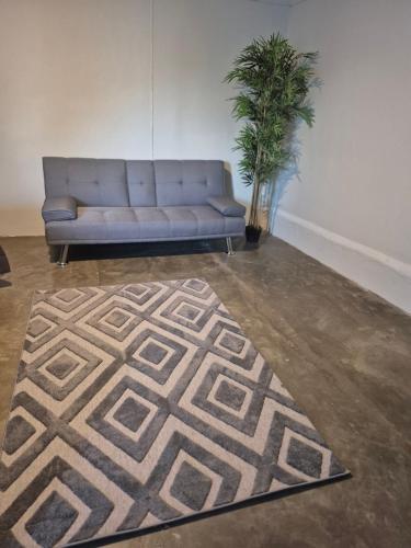 a couch in a living room with a rug at Studio 40 in Tequila