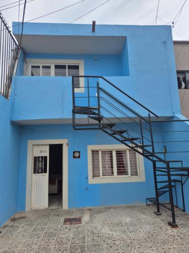 a blue house with a staircase in front of it at Studio 40 in Tequila