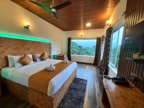 a bedroom with a large bed with a large window at Spring Muunnar, Munnar in Munnar