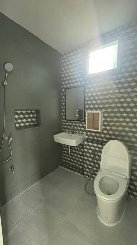 a bathroom with a toilet and a sink at Aysaii Home01 in Panwa Beach