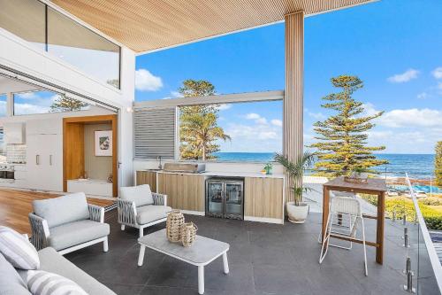 a kitchen and living room with a view of the ocean at The Grand Ocean Vista in Shellharbour