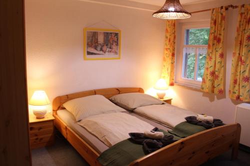 a bedroom with two beds with stuffed animals on them at HerrBerge Pilgerglück in Eibenstock