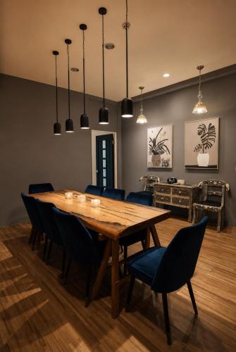a dining room with a wooden table and chairs at Chloechen Home in Taitung City