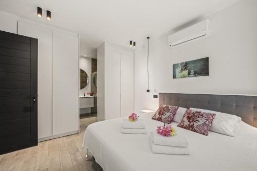 a bedroom with a white bed with two pillows at Ocean View Apartment 384 Blue Bay in Dorp Sint Michiel