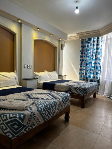a hotel room with two beds and a mirror at Hotel kristal in La Barca