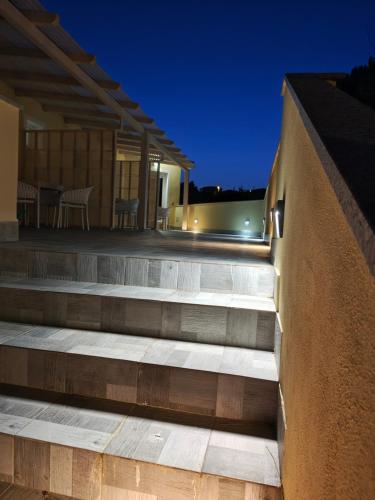 a set of stairs leading up to a house at night at Case Vacanza il Sole in La Maddalena