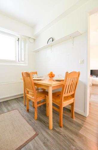a dining room with a wooden table and chairs at Helmiapartments Sotkamo in Sotkamo