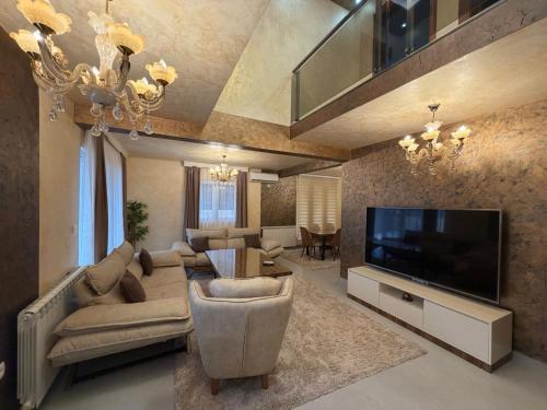 a living room with a couch and a television at Vila Sami in Bar