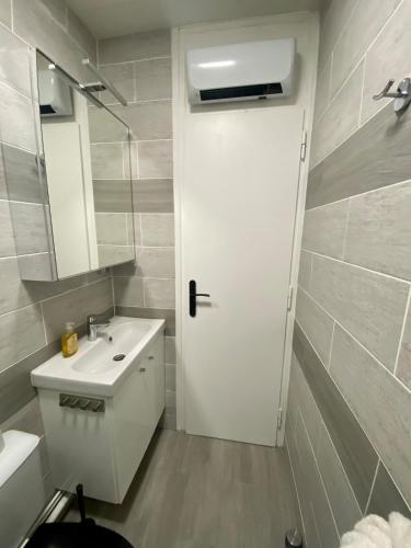 a bathroom with a white door and a sink at Welcome to Star Vars! in Vars