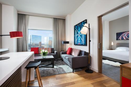 a junior suite with a king bed and a living room at Hyatt Regency Bloomington - Minneapolis in Bloomington