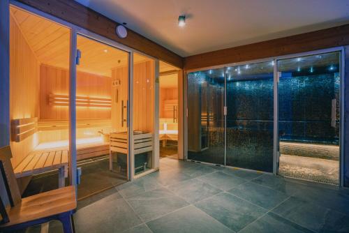 an empty sauna in a room with glass doors at Terra-Beka Lodge in La Chapelle-dʼAbondance