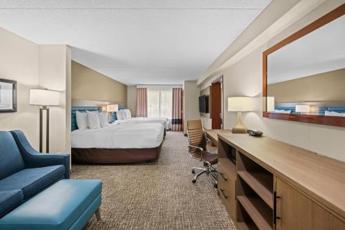 a large hotel room with a bed and a desk at Comfort Suites Near Gettysburg Battlefield Visitor Center in Gettysburg