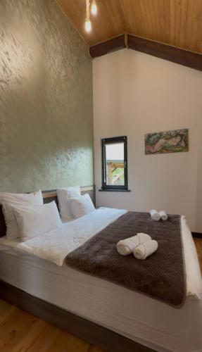 a bedroom with a large bed with towels on it at LerHouseDilijan in Dilijan