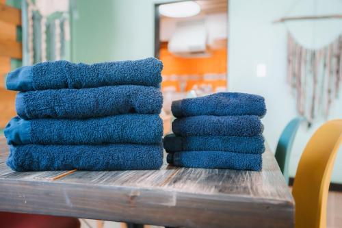 a pile of blue towels sitting on a table at Cottage ke'oke'o in Yomitan