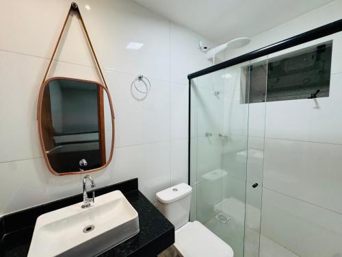 a bathroom with a sink and a glass shower at Loft Hage in Belém