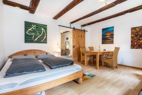 a bedroom with a bed and a dining room at Fuchsrevier Fox District Apartment in Erkerode