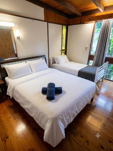 two beds in a room with two blue towels on them at ALRA2 Accommodations in Brisbane