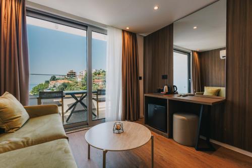 a living room with a couch and a table at Hotel Mediterraneo Liman in Ulcinj