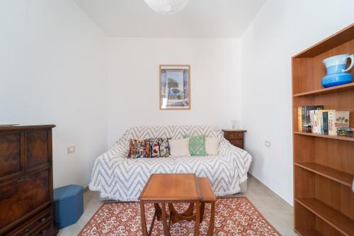 a living room with a couch and a table at Tia Maria - Tradizione e Autenticità in Ploaghe