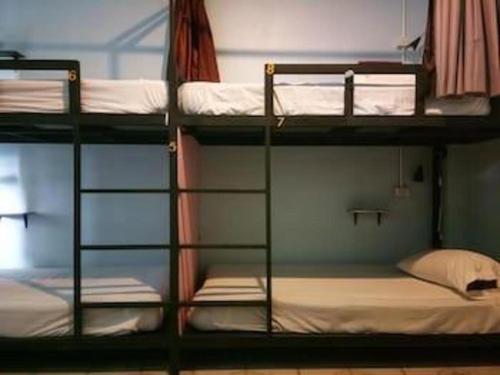 two bunk beds in a dorm room with at The 25 Hostel in Sathani Khlong Rian