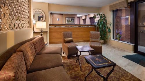 a living room with a couch and two chairs at MHO INN and SUITES in Monmouth Junction
