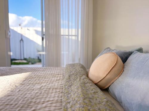 a bedroom with a bed with a couch and a window at Studio Jean - Dog-Friendly in Bremer Bay