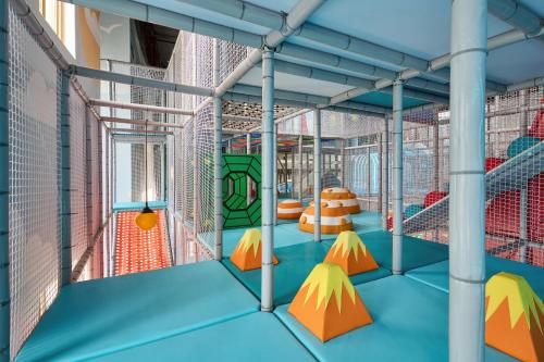 an indoor playground with orange and yellow equipment at Arda Angariki in Khiva