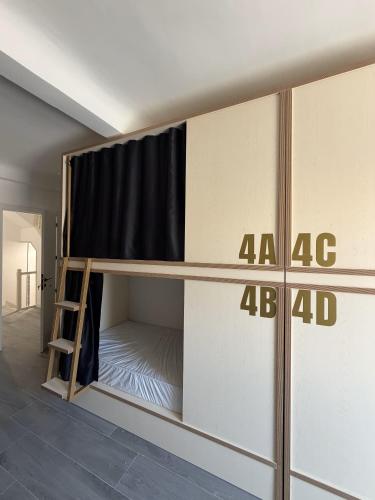 a bunk bed in a room with the number at Albergue -Hostel ManuelaINN in El Burgo de Osma