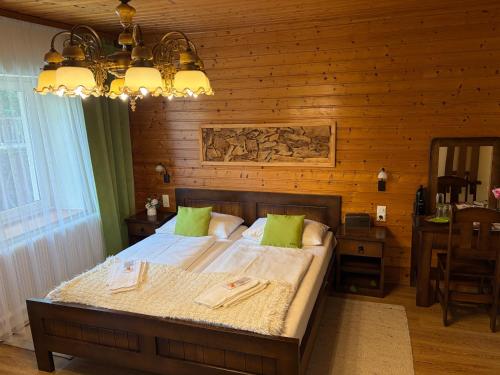 a bedroom with a bed and a wooden wall at Waldhotel Bad Jungbrunn in Tristach
