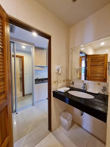 a bathroom with a sink and a large mirror at Surin Sabai Residence near Surin Beach in Surin Beach