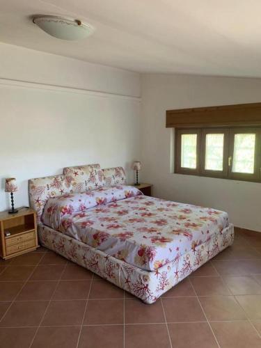 a bedroom with a large bed in a room at La Favola Verde in Roccadaspide