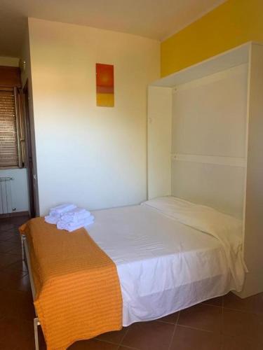 a bedroom with a white bed in a room at La Favola Verde in Roccadaspide