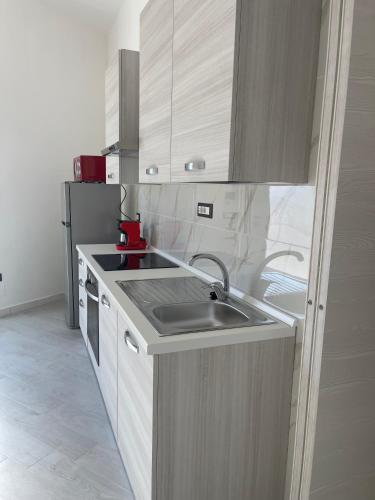 a kitchen with a sink and a refrigerator at Casa Vacanze Nautilus in Termoli