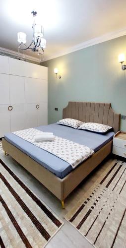 a bedroom with a large bed with a blue mattress at Яншина 2 in Qyzylorda