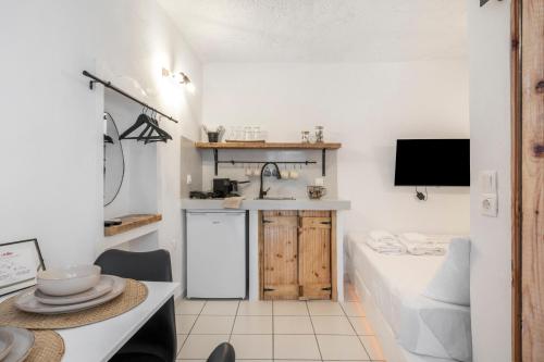 a small kitchen with a sink and a counter at Bougainvillea in Andros