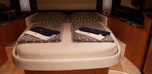 a small bed with two pillows on it at Houseboat Dolce Vita in Novigrad Istria