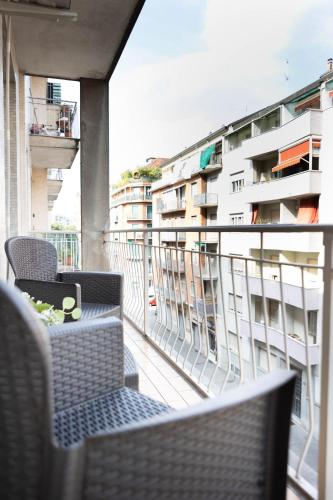 a balcony with chairs and a table and a building at House Santa Rita in Turin